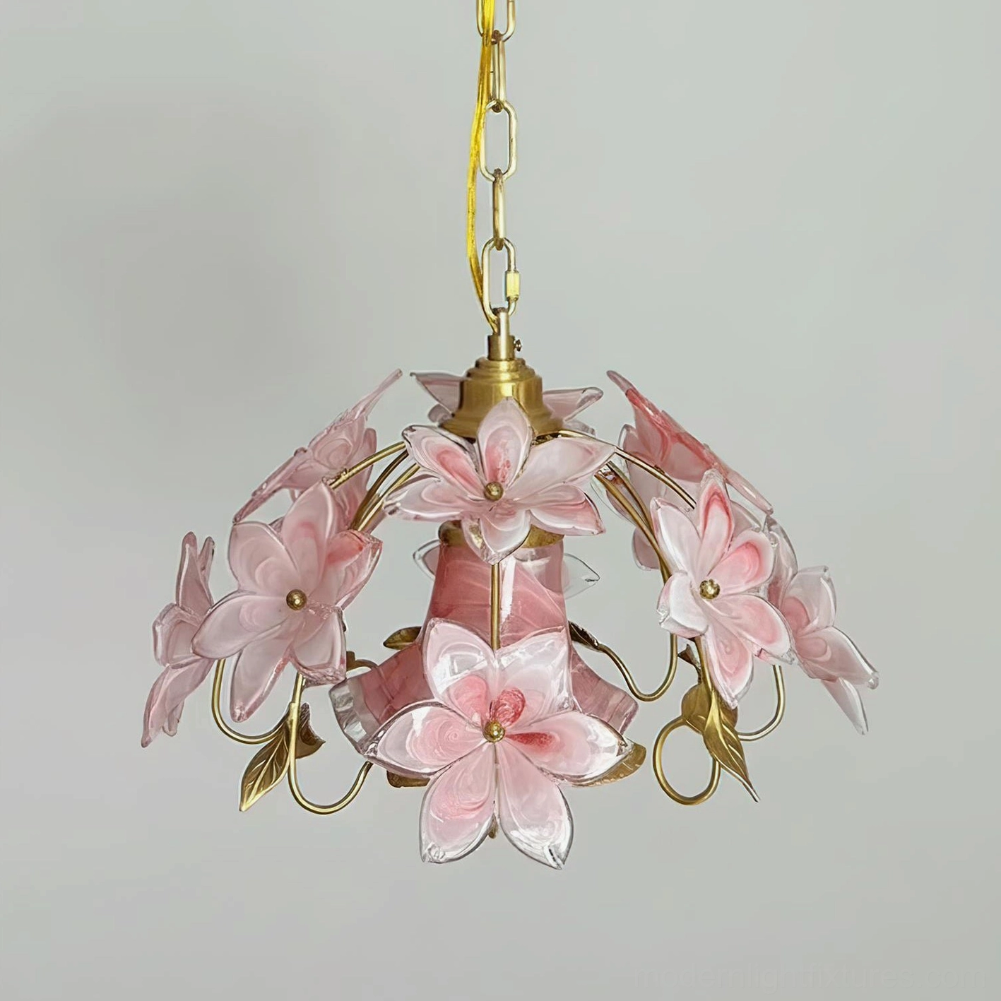 Brass and pink Murano glass pendant light in elegant interior setting, artistic sculptural form