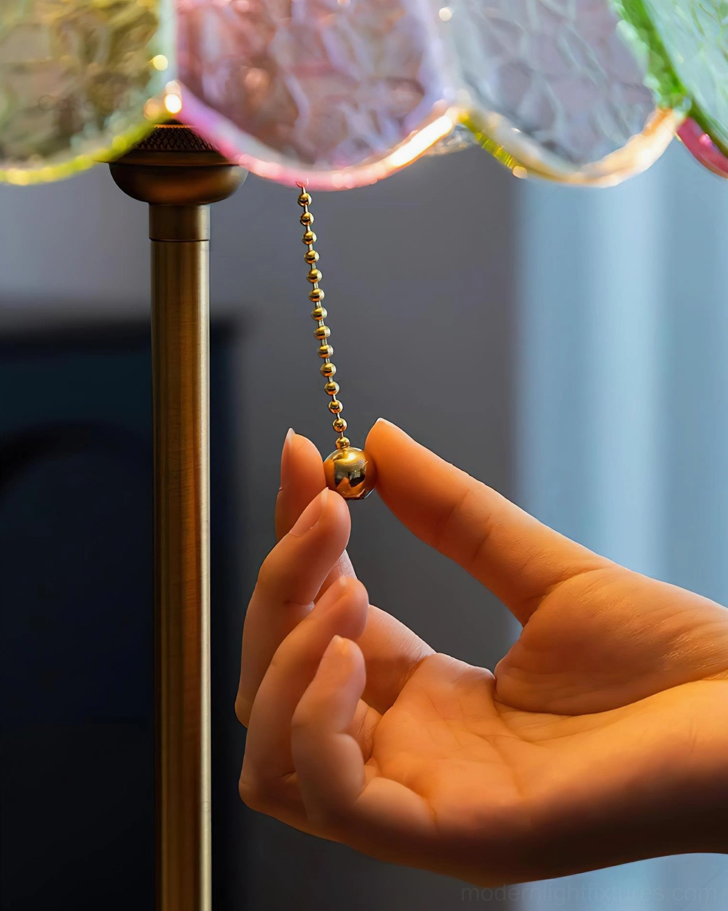 Brass pull chain switch detail on vintage scalloped glass table lamp close-up