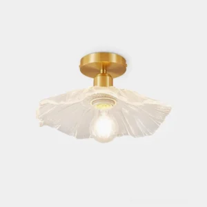 Vintage brass ruffled glass semi-flush ceiling light fixture front close-up view with clear textured shade and exposed Edison bulb