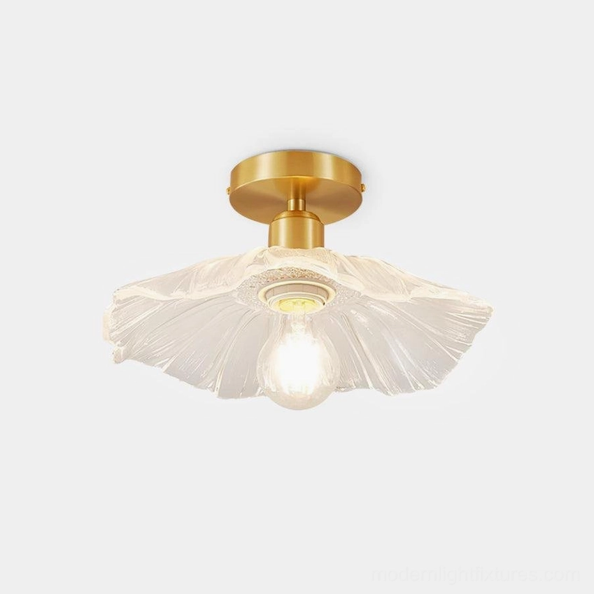 Vintage brass ruffled glass semi-flush ceiling light fixture front close-up view with clear textured shade and exposed Edison bulb