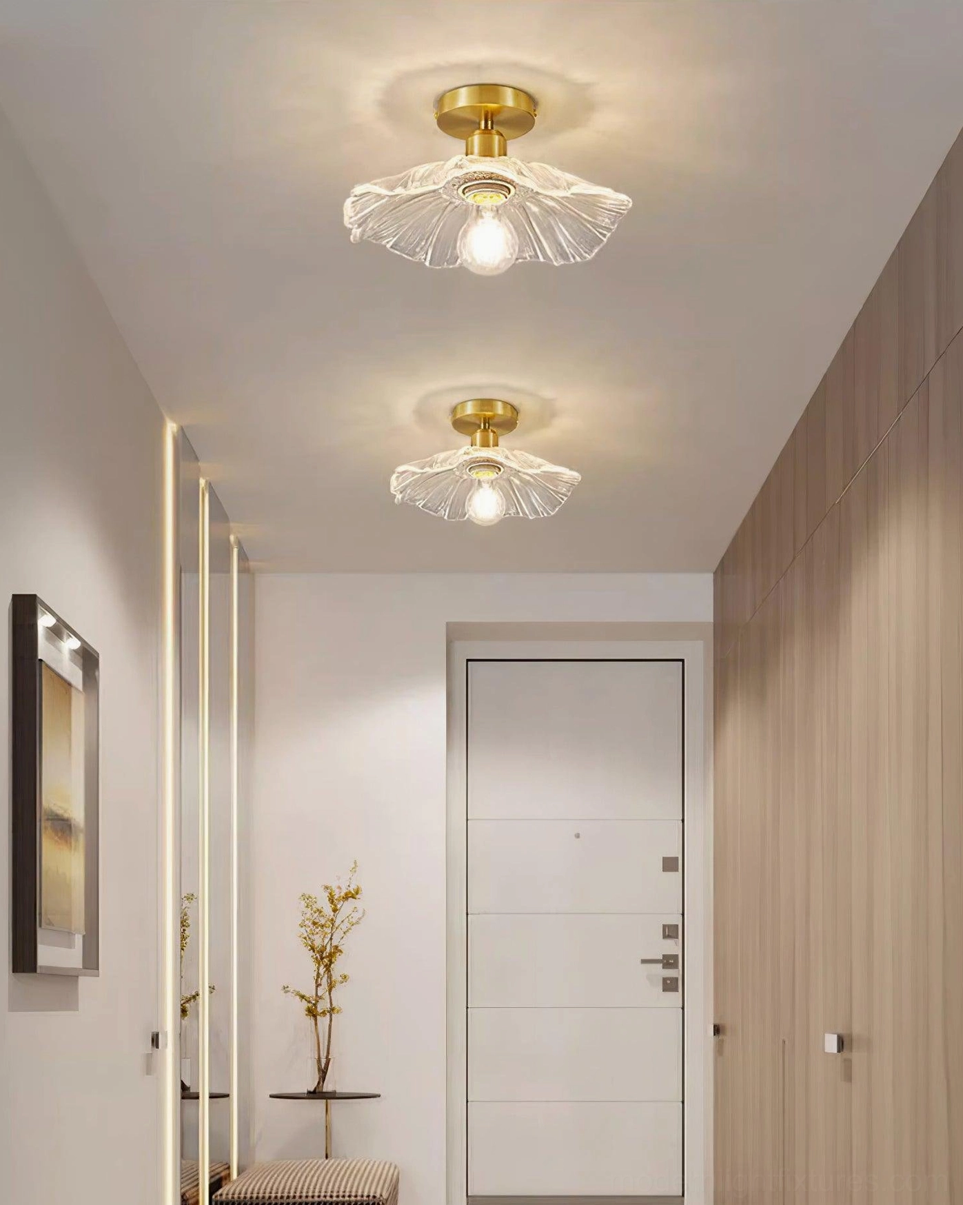 Ruffled glass semi-flush ceiling fixture mounted in interior hallway with brass finish complementing neutral wall tones