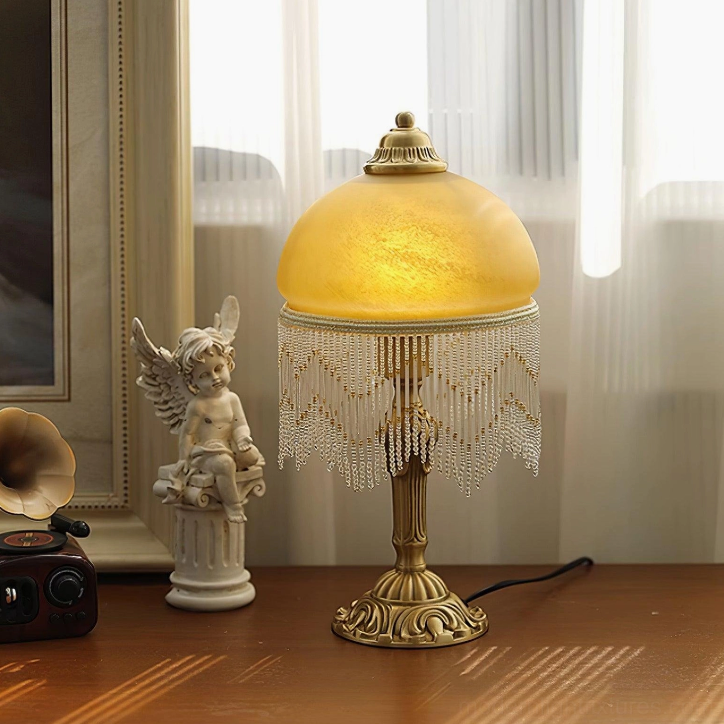 Vintage brass table lamp with amber glass shade displayed on wooden desk with European retro home decor and warm glowing light