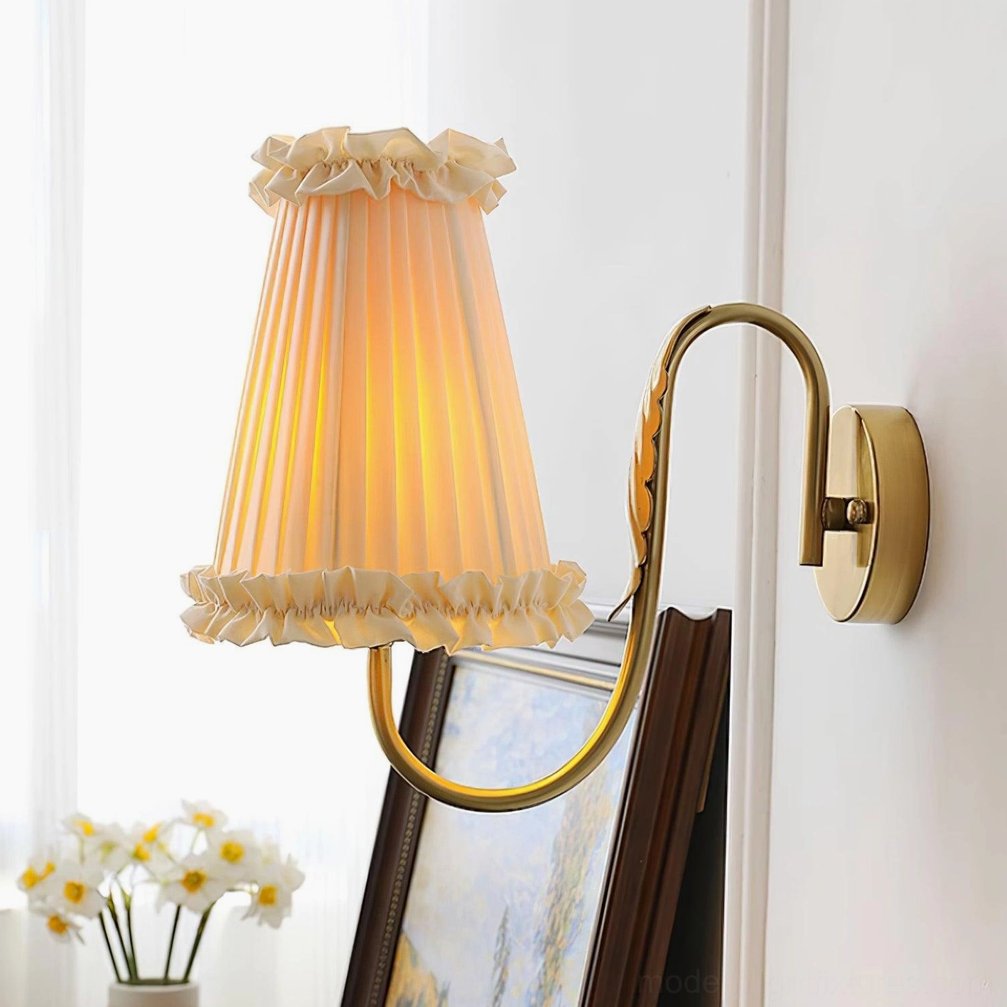 Glowing brass wall lamp with ruffled pleated shade and curved brass arm