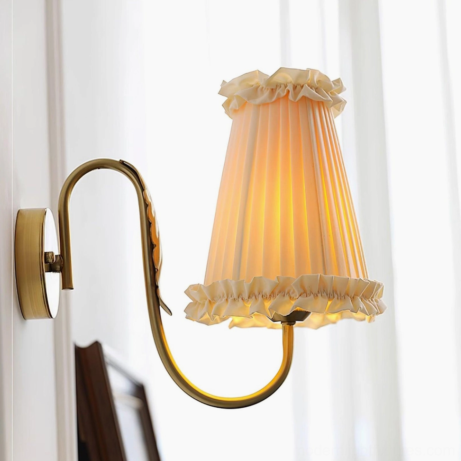 Brass wall sconce arm and wall mount hardware in gold finish close-up