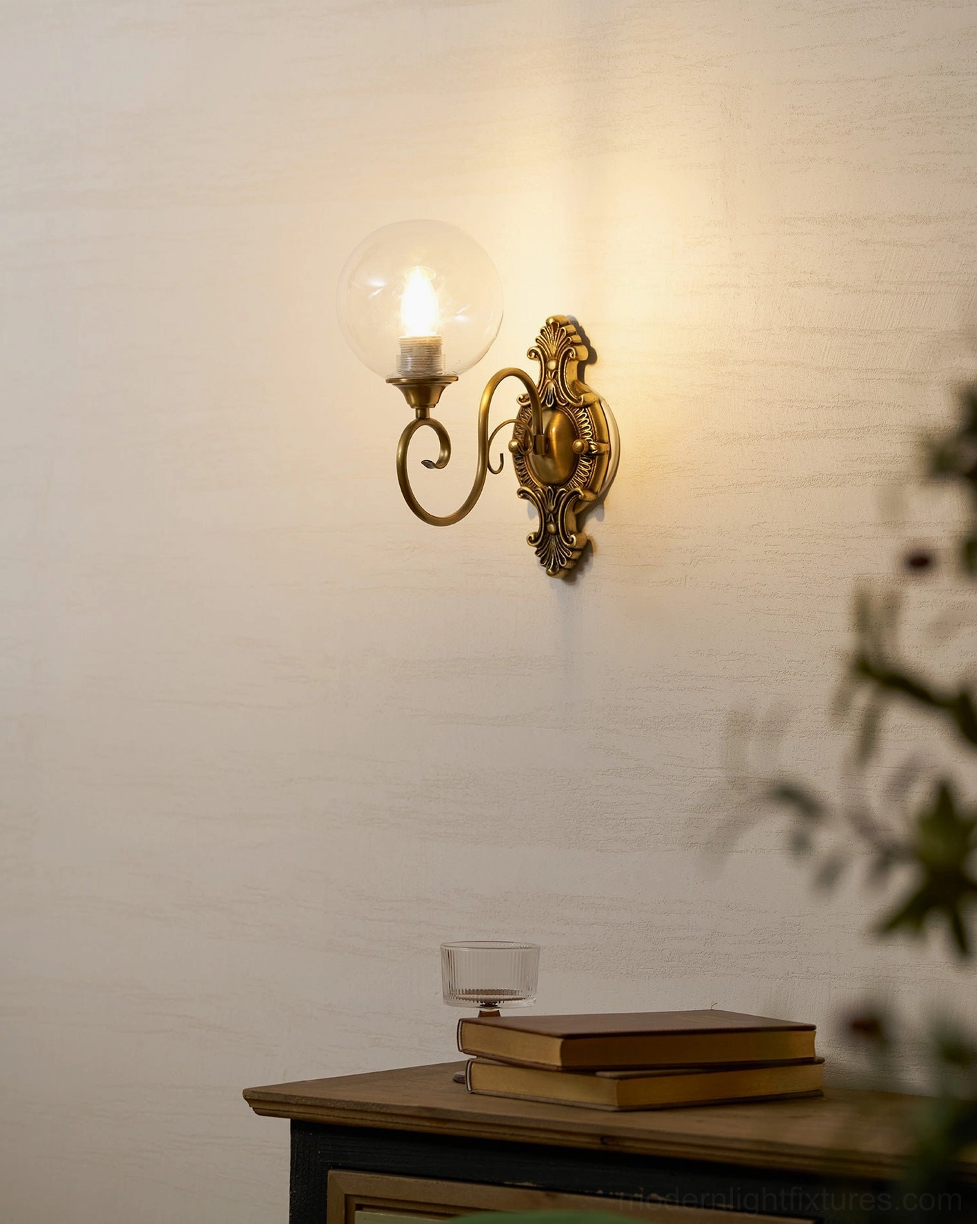 Close-up of ornate brass wall sconce arm and socket assembly, vintage E14 brass fixture detail