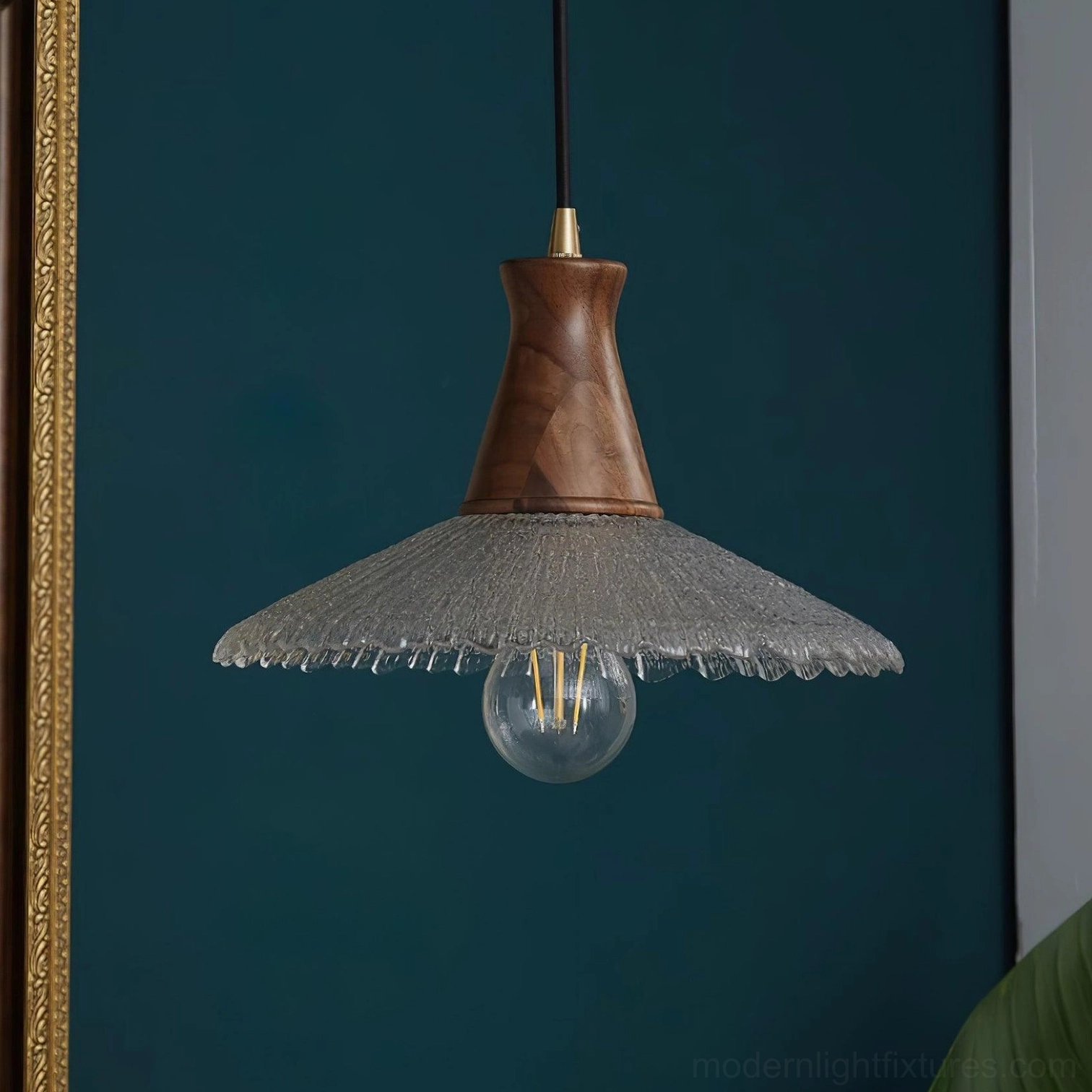 Brass and walnut pendant fixture with clear ribbed glass in modern dining room design context