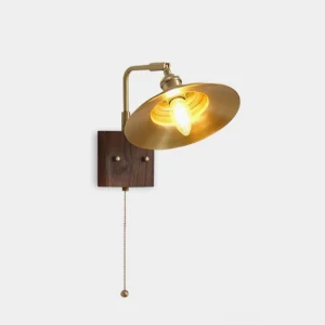 Brass and walnut mid-century wall sconce with polished brass finish and adjustable swing arm