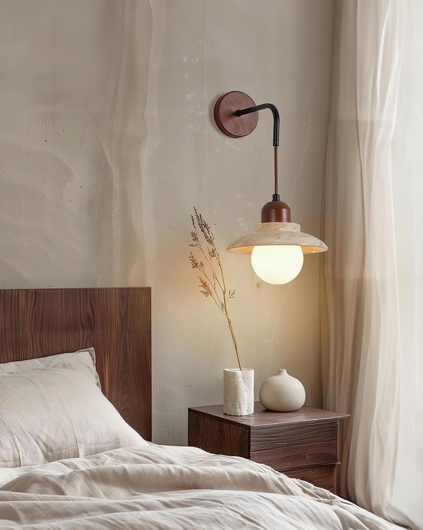 Brava wall sconce installed in modern bedroom above bedside table creating warm ambient lighting