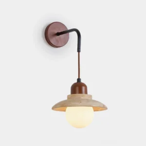 Brava travertine wall sconce front view showing dome-shaped natural stone shade with matte black metal frame