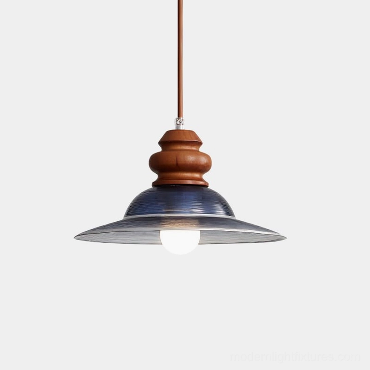 Brenna modern pendant light with deep blue glass shade and walnut wood mount, close-up overhead view