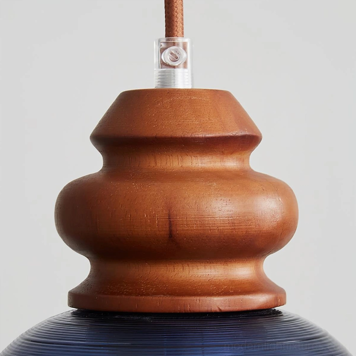 Brenna pendant light with deep blue glass shade and sculptural wood neck, minimalist design