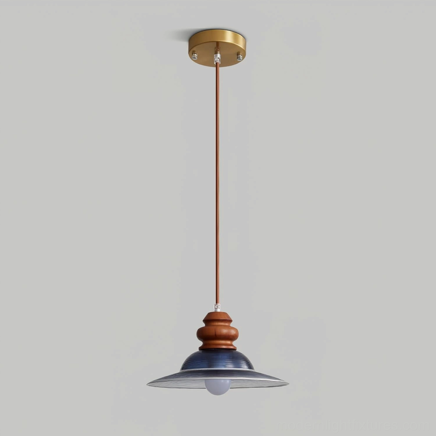 Brenna pendant light fixture with brass hardware, wood mounting post, and blue glass shade