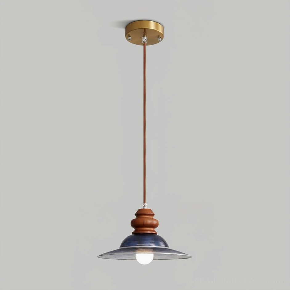 Brenna pendant light with brass ceiling mount and brown wood rod, deep blue glass shade detail