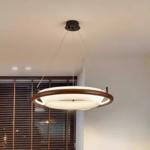 Breno warm wood tone pendant chandelier in three-quarter view above wooden dining space