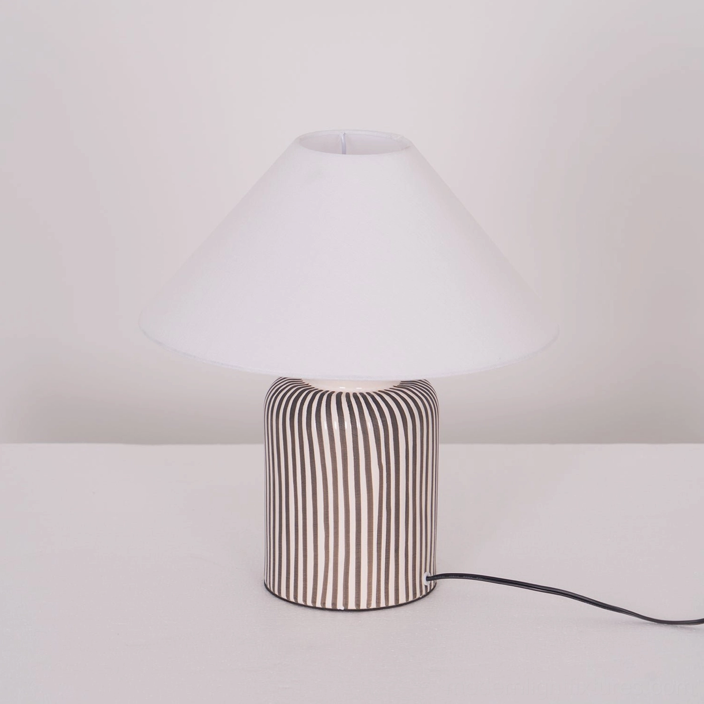 Brenton hand-painted striped ceramic lamp showcasing unique design elements and fabric shade construction