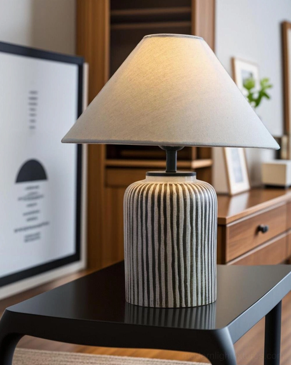 Hand-painted striped table lamp positioned on bedroom side table with framed wall art and wooden cabinet