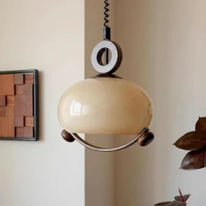 Briette mid-century pendant lamp in home interior - warm glow with wooden wall art and potted plant accent