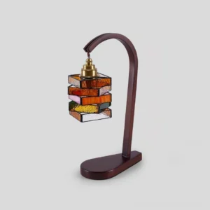 Modern Brikra table lamp showing geometric stacked glass brick construction and curved wooden base with brass accents
