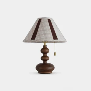 Brimley sculptural wooden table lamp with plaid fabric shade and walnut ash base, front studio view