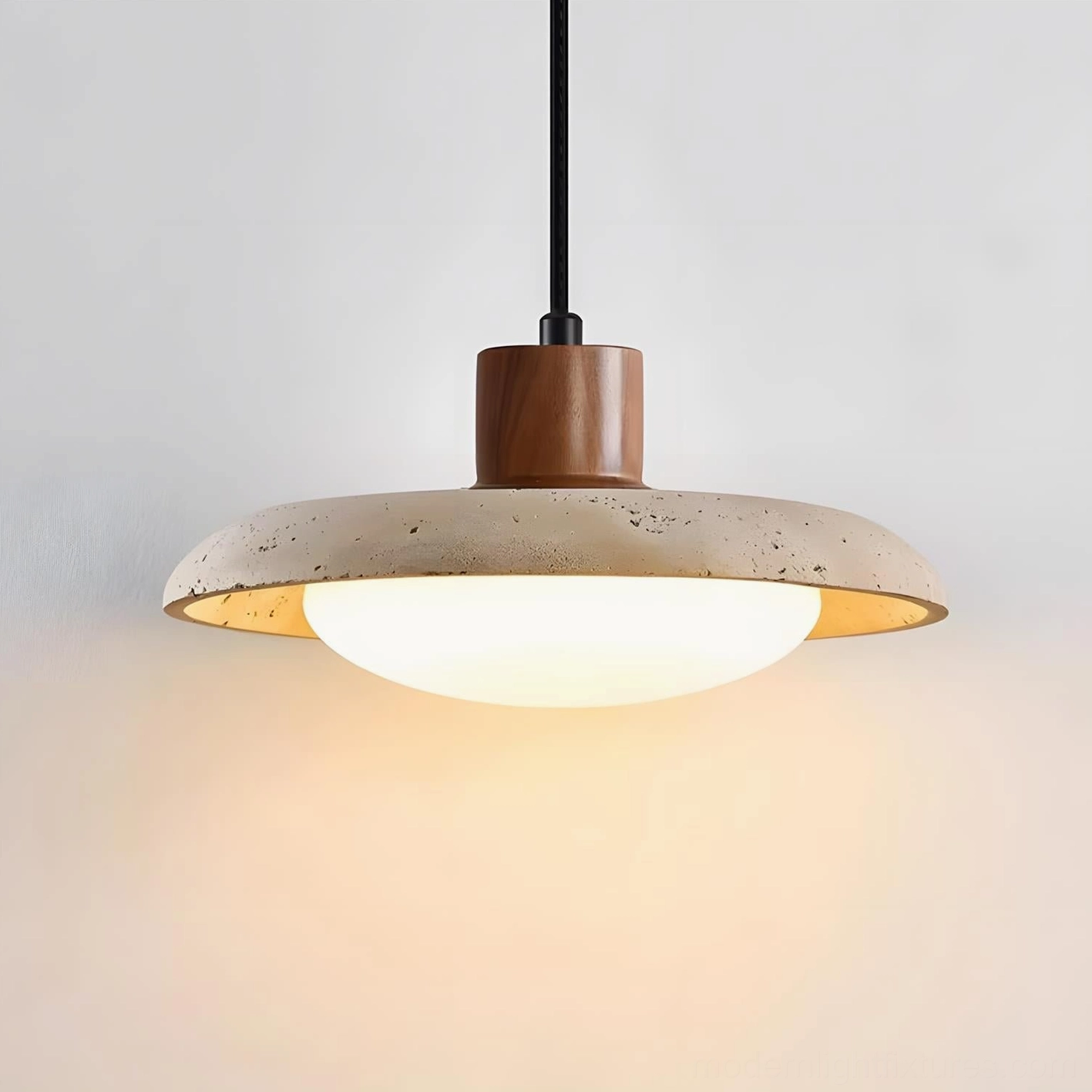 Three-quarter angle view of travertine pendant light showcasing wooden mount, gold trim detail, and frosted acrylic diffuser
