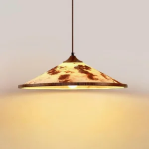 Illuminated brindle pendant lamp showing warm ambient glow through textured rice paper, three-quarter view