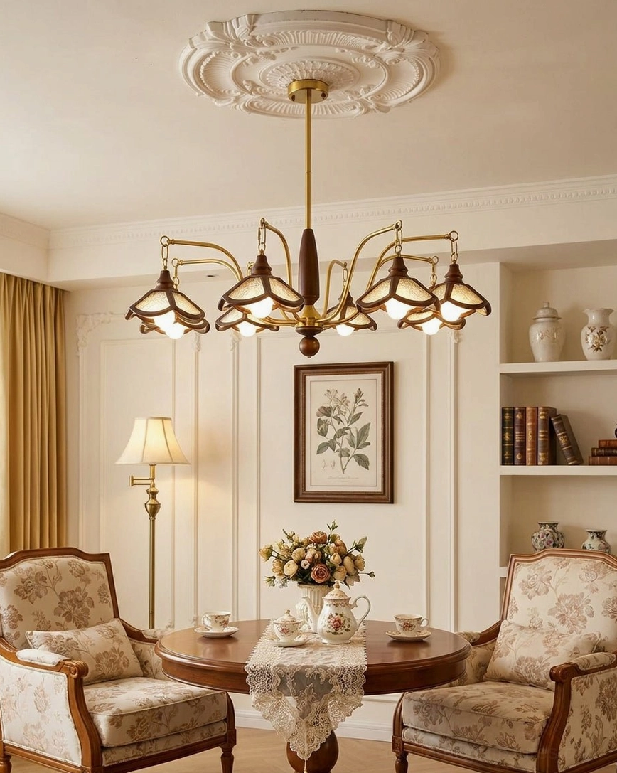 Vintage wood-and-brass multi-arm chandelier in cozy living room space with upholstered armchairs and warm lighting ambiance