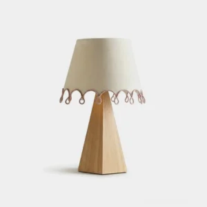 Brinelle tapered fabric table lamp with wooden pyramid base, front view on white studio background
