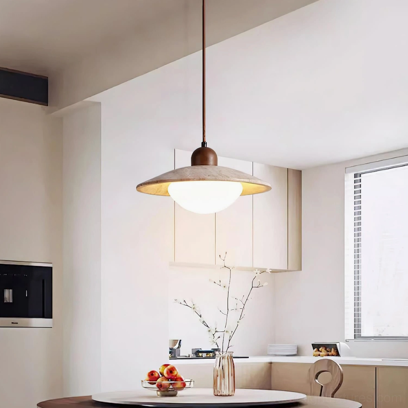 Brio pendant light hanging over modern dining table in kitchen setting