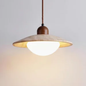 Close-up detail of Brio pendant light shade showing natural travertine texture and beige finish