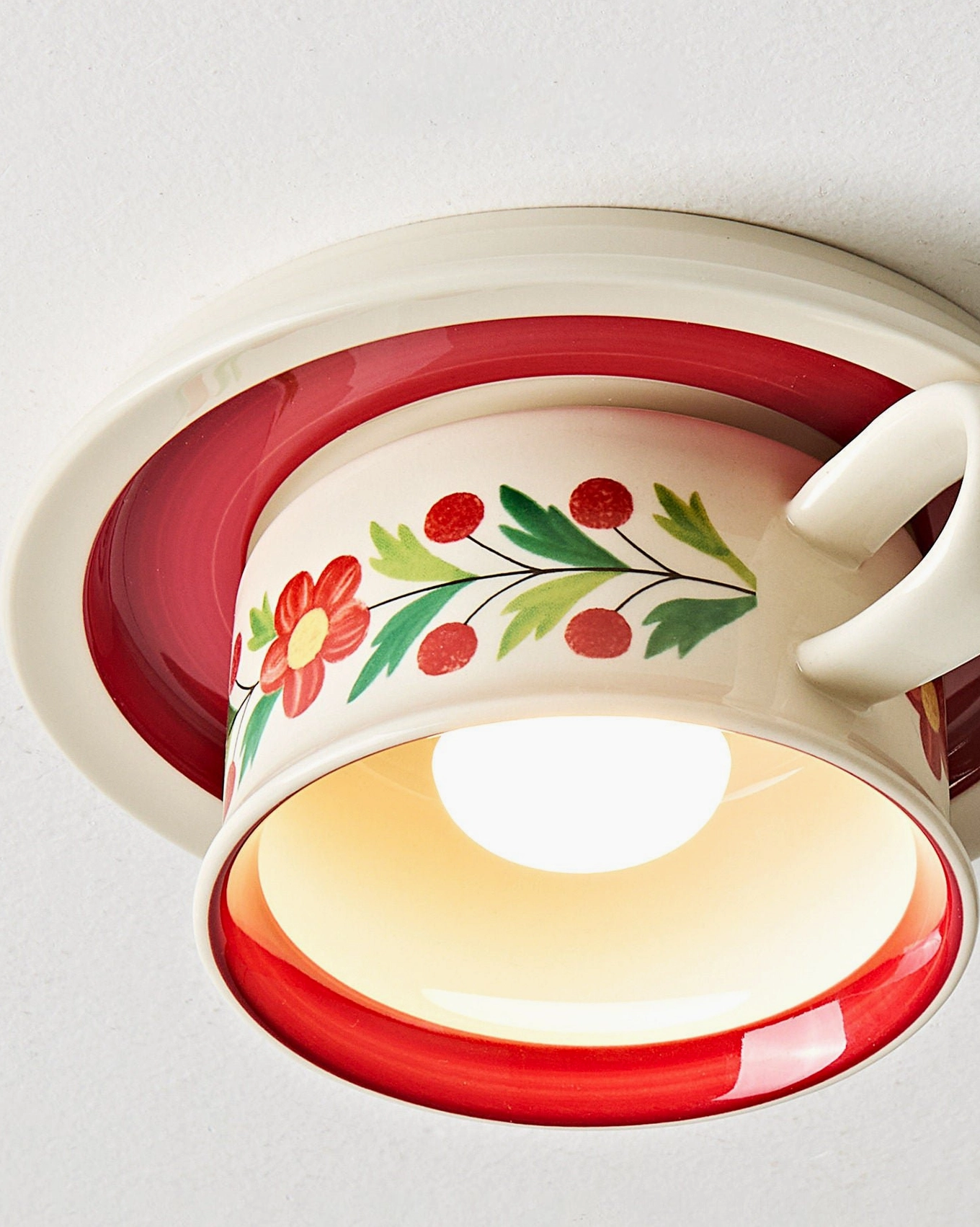 Brisa ceramic tea cup ceiling light installed showing downward illumination and warm ambient glow effect