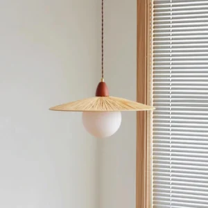 Briuna pendant light side view showing twisted brown cord and warm natural texture in minimalist interior setting