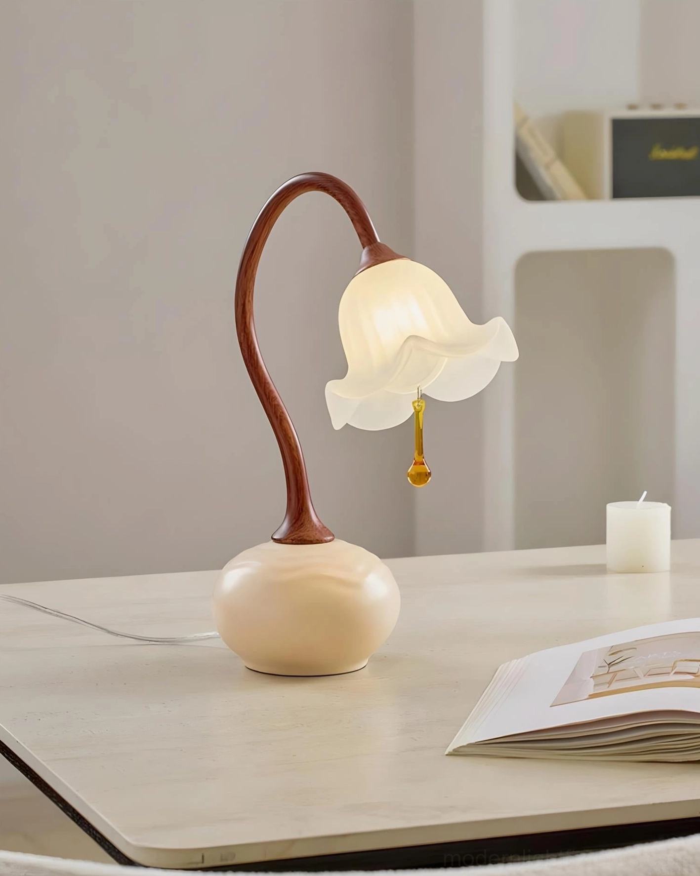 Brivana table lamp tabletop close-up with book and candle - minimalist home decor styling