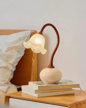 Brivana table lamp on bedroom nightstand with stacked books and warm lighting - japandi bedside design