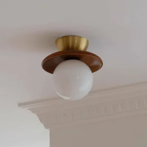 Gold and walnut Brody globe semi-flush ceiling light mounted on residential ceiling with crown molding detail