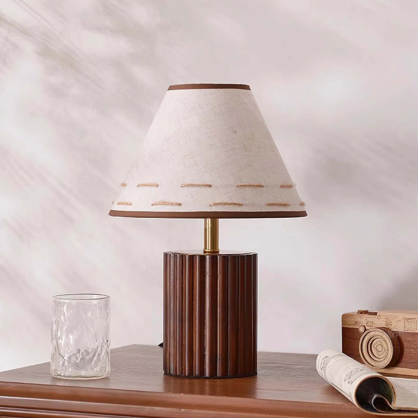 Brooke wooden table lamp with walnut base angled view showing fabric shade detail and stitched trim on wooden dresser
