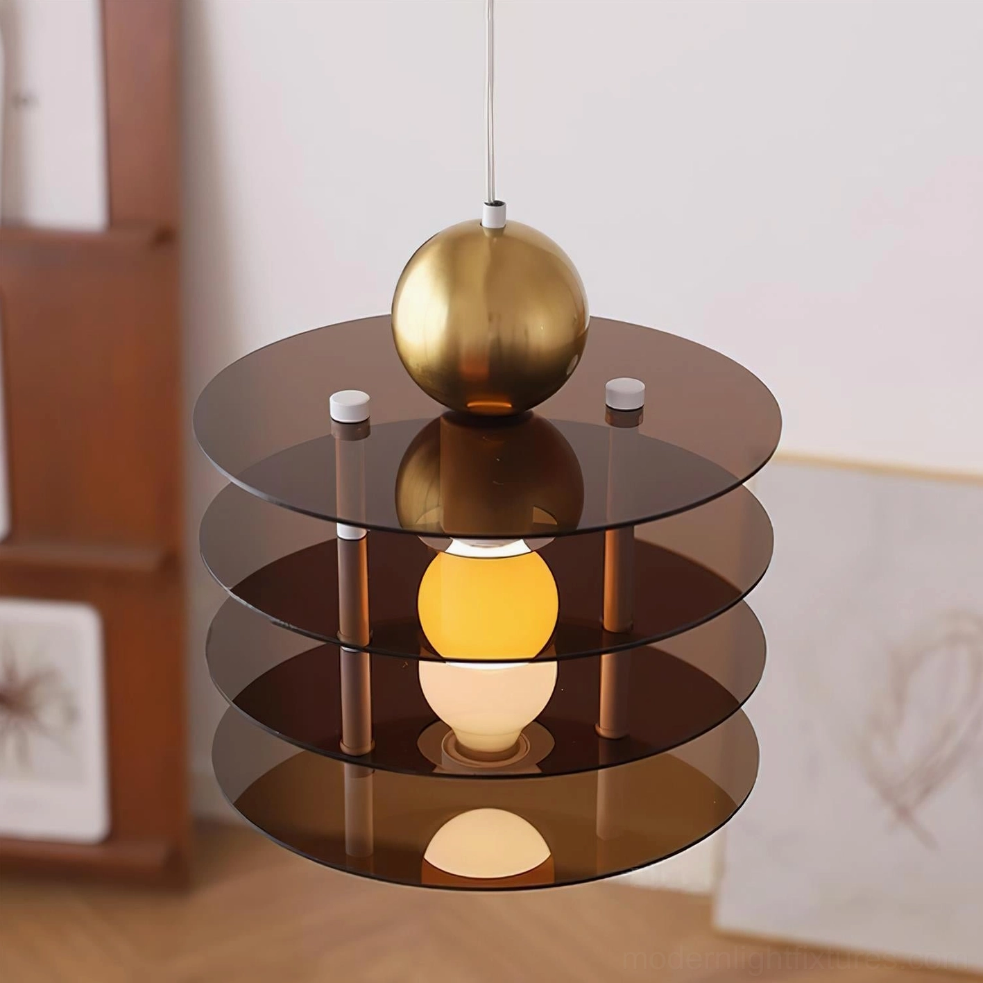 Brown and gold modern pendant light with tiered acrylic disc design