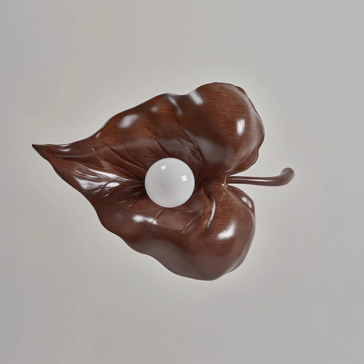 Brown finish maple leaf shaped resin pendant lamp with suspension wires against neutral background