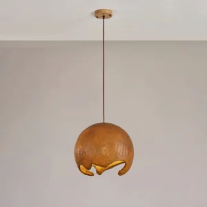 Brown moon crater pendant lamp hanging from wooden ceiling mount with black cord, displaying rough texture and warm light diffusion