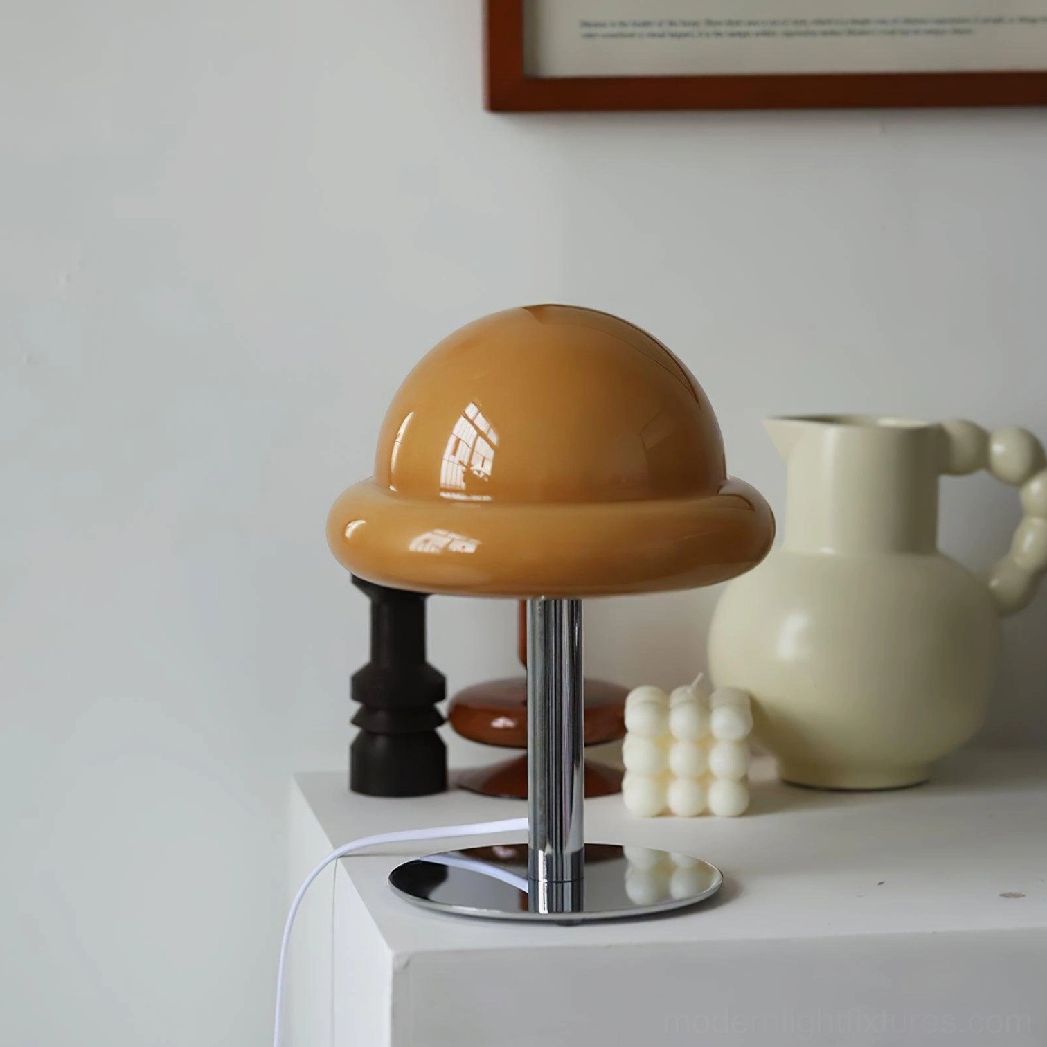 Caramel brown glossy glass mushroom lamp displayed on bedroom dresser with home décor accessories