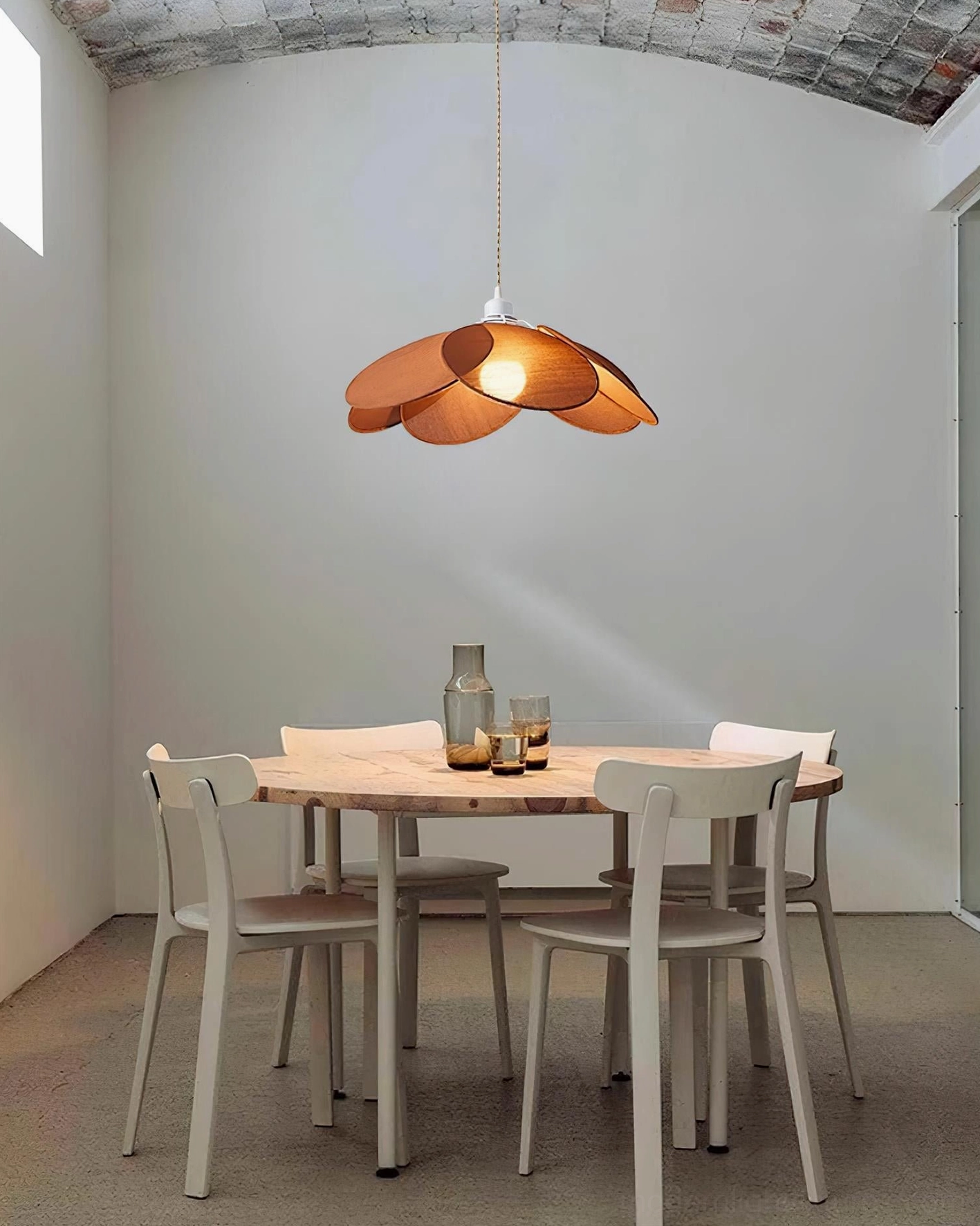 Brown petal pendant lamp in Nordic minimalist dining space with round table setup