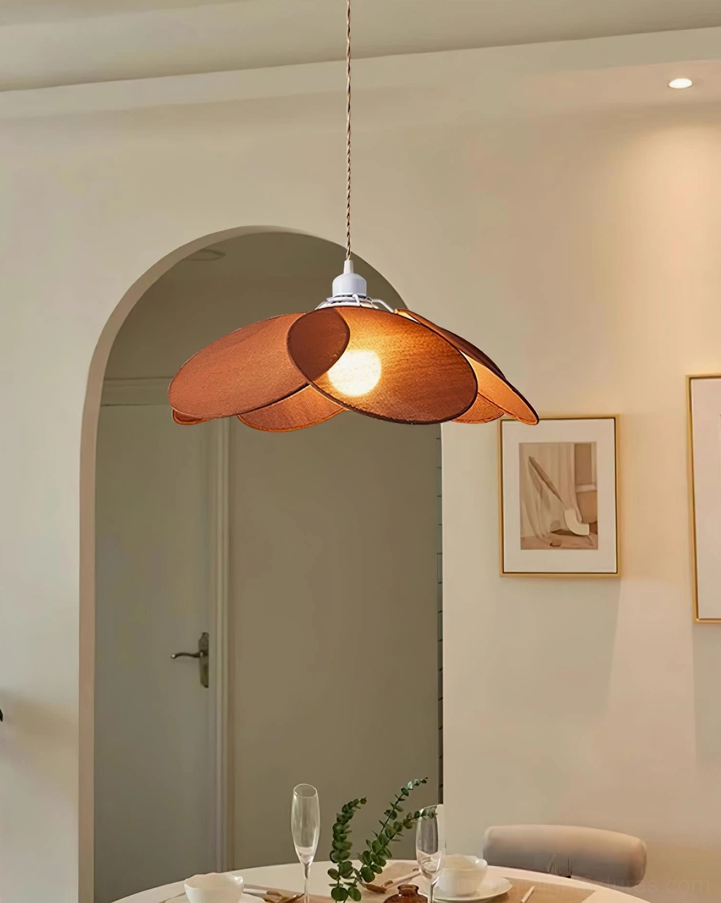 Brown petal pendant light in modern dining room with arched doorway and wooden accents