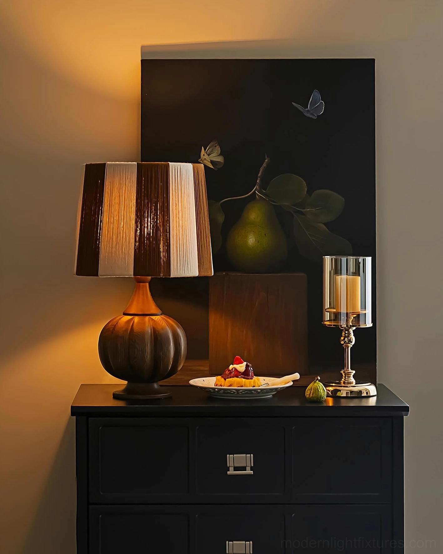 Brown striped wooden table lamp lit on dark cabinet in vintage dining corner with dessert and candle decor