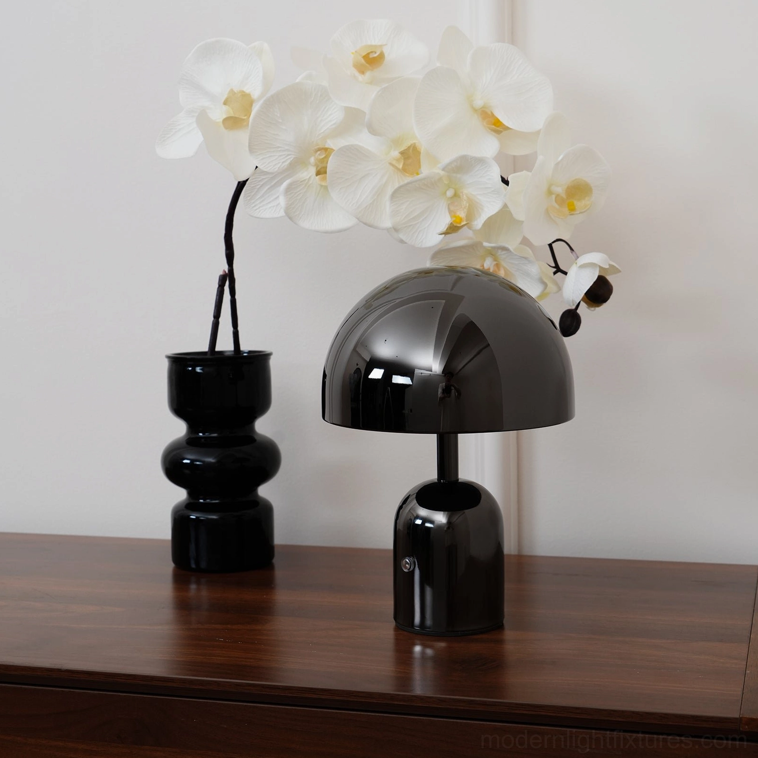 Black modern Brulee table lamp with three-color changing LED on minimalist nightstand