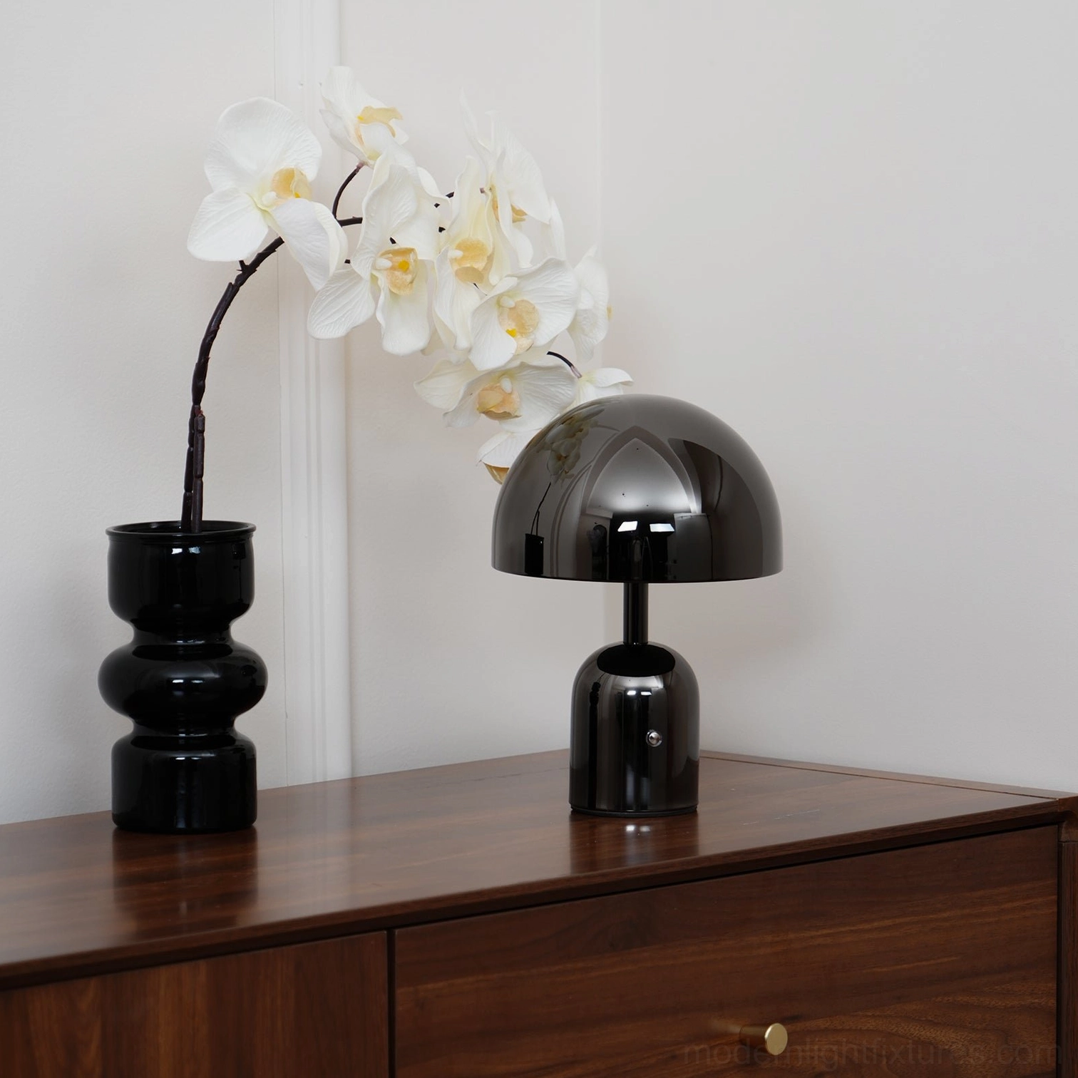 Black Brulee table lamp in contemporary bedroom setting providing warm ambient evening lighting