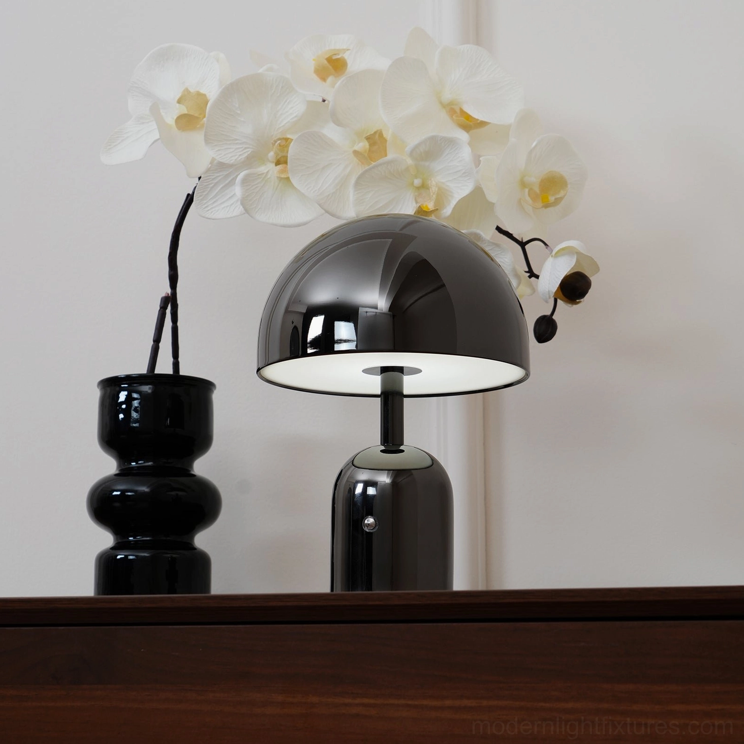 Rose gold Brulee portable lamp creating soft contemporary lighting in modern apartment living space