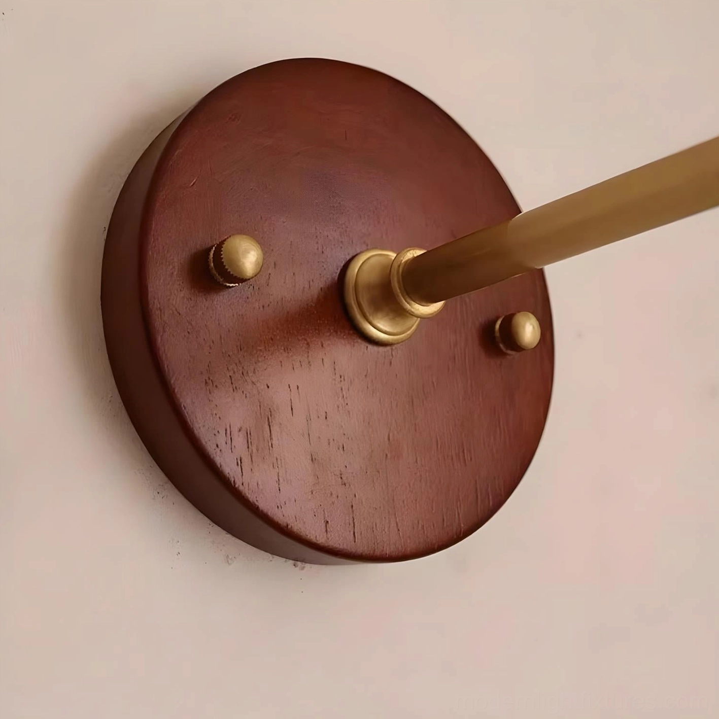 Bruma wall sconce curved brass arm and wood base construction detail