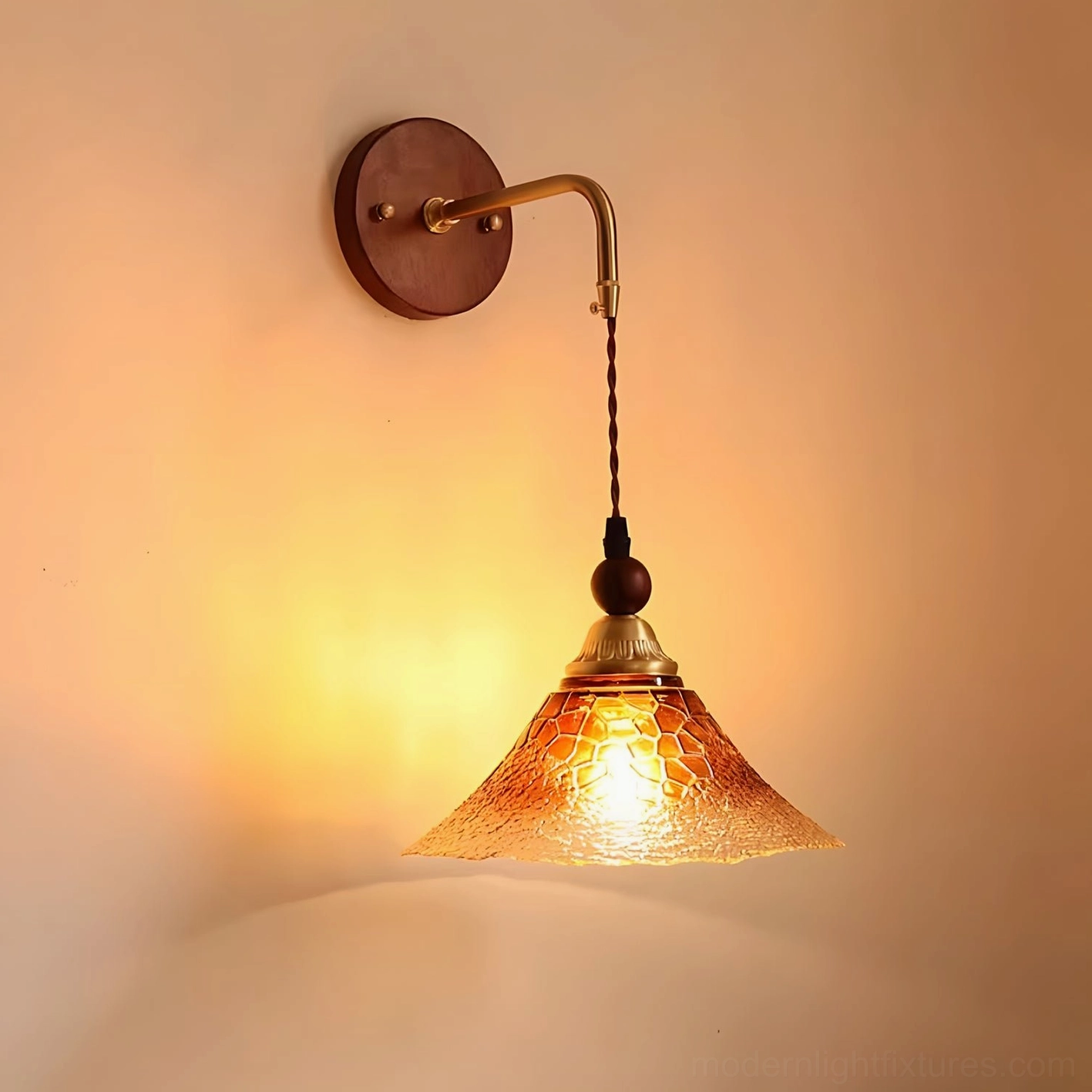 Bruma wall sconce mounted installation showing warm brass finish and glass diffuser
