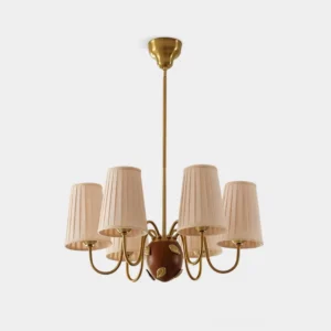 Brunel Grove 8-light fabric chandelier with pleated beige shades and brass arms, front view on white studio background
