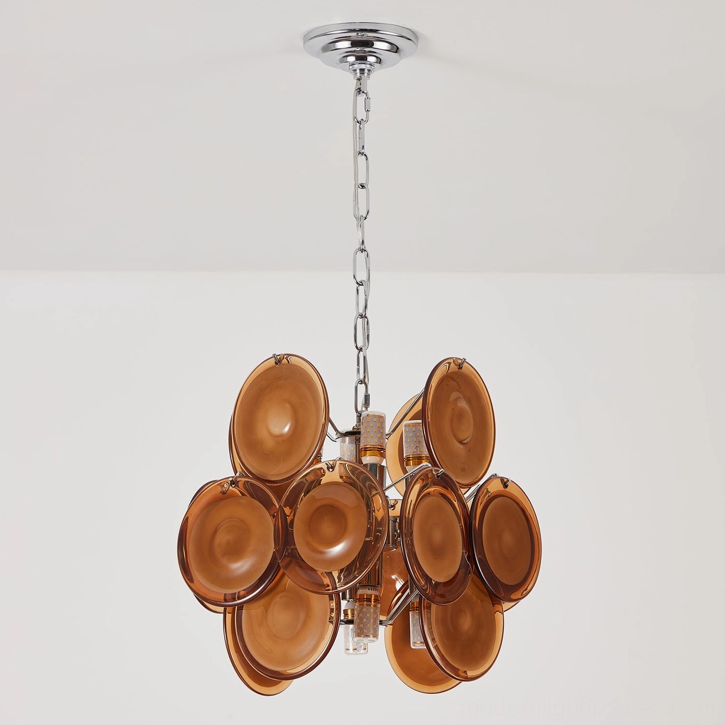Brunelle amber glass disc pendant chandelier showing warm color finish and golden-hour glow characteristics