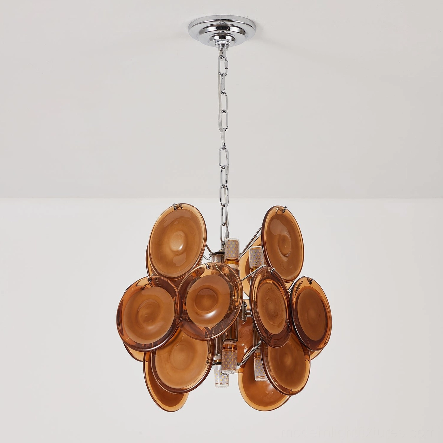 Left side three-quarter view of amber glass disc pendant chandelier, highlighting detailed metal and glass structure